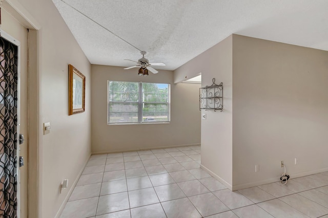 393 Fanshaw J, Boca Raton, FL 33434 - empty room with a ceiling fan, light tile patterned flooring, a textured ceiling, and baseboards