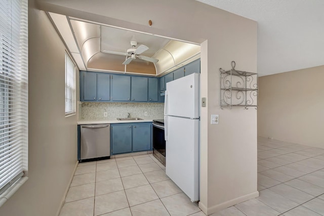 393 Fanshaw J, Boca Raton, FL 33434 - kitchen featuring stainless steel appliances, blue cabinets, a sink, light countertops, and light tile patterned floors