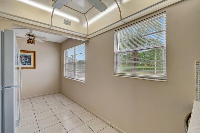 393 Fanshaw J, Boca Raton, FL 33434 - empty room with ceiling fan, light tile patterned floors, and baseboards