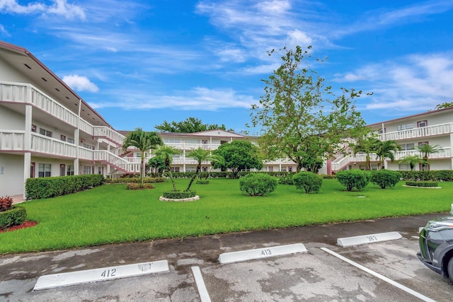393 Fanshaw J, Boca Raton, FL 33434 - surrounding community with uncovered parking and a lawn