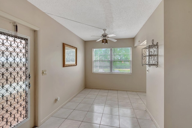 393 Fanshaw J, Boca Raton, FL 33434 - foyer with a ceiling fan, a textured ceiling, light tile patterned floors, and baseboards