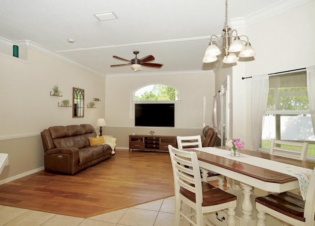 1985 SW Glenco St, Port Saint Lucie, FL 34953 - dining room with healthy amount of natural light, a chandelier, ornamental molding, and light tile patterned flooring