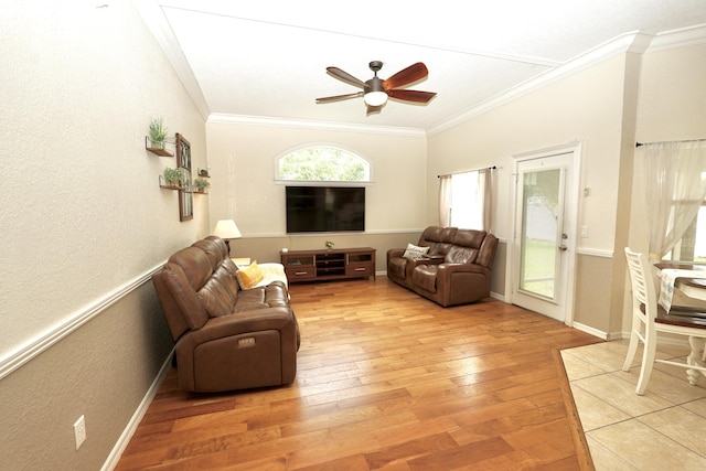 1985 SW Glenco St, Port Saint Lucie, FL 34953 - living room featuring crown molding, light wood-type flooring, ceiling fan, a textured wall, and baseboards