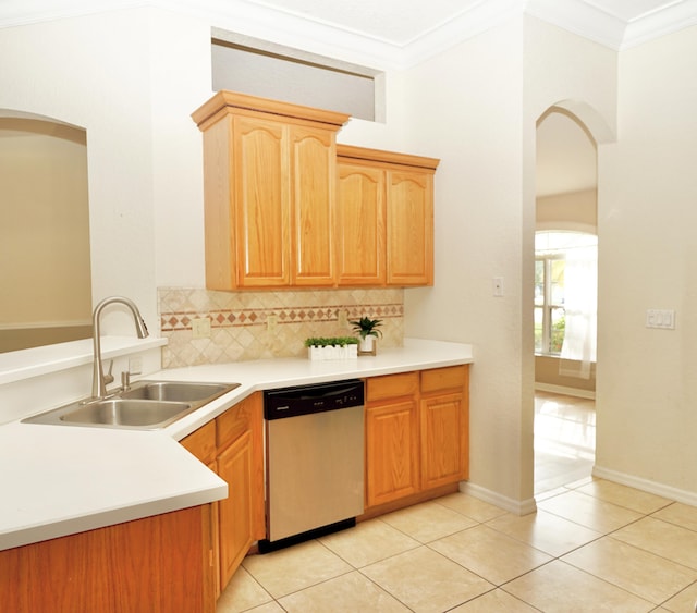 1985 SW Glenco St, Port Saint Lucie, FL 34953 - kitchen featuring dishwasher, a sink, crown molding, arched walkways, and decorative backsplash