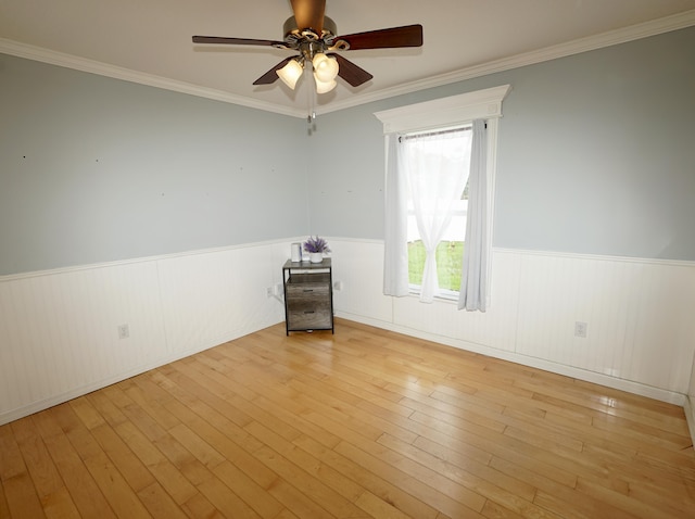 1985 SW Glenco St, Port Saint Lucie, FL 34953 - empty room with wainscoting, ceiling fan, hardwood / wood-style floors, and ornamental molding