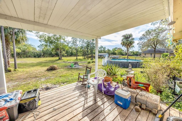 18564 48th Ave N, The Acreage, FL 33470 - wooden terrace with an outdoor pool, a yard, and view of wooded area