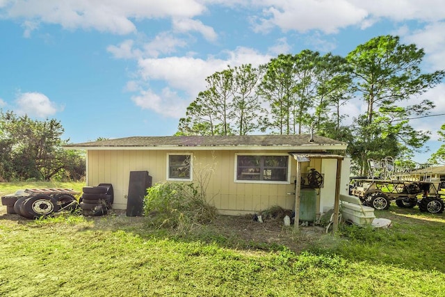 18564 48th Ave N, The Acreage, FL 33470 - rear view of property featuring a lawn