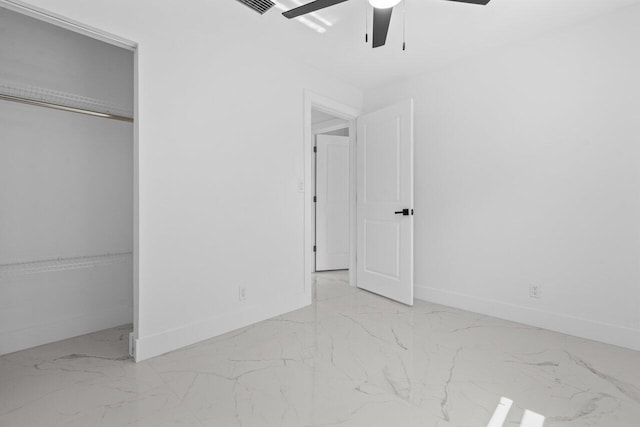 2949 NE 12th Ter, Pompano Beach, FL 33064 - unfurnished bedroom featuring marble look tile flooring, baseboards, ceiling fan, and a closet