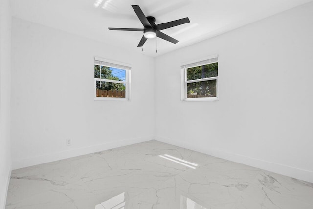 2949 NE 12th Ter, Pompano Beach, FL 33064 - empty room featuring baseboards, healthy amount of natural light, and marble finish flooring