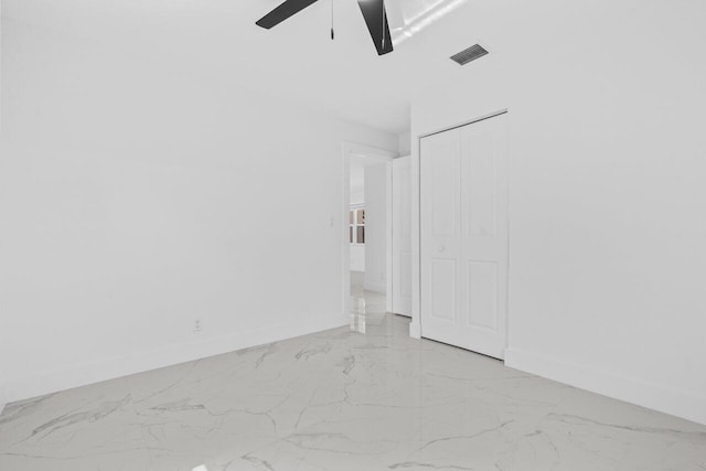 2949 NE 12th Ter, Pompano Beach, FL 33064 - spare room featuring light marble finish floors, a ceiling fan, and baseboards