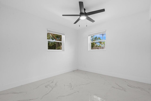 2949 NE 12th Ter, Pompano Beach, FL 33064 - spare room with baseboards, light marble finish floors, and healthy amount of natural light