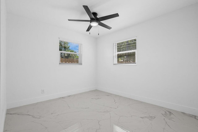 2949 NE 12th Ter, Pompano Beach, FL 33064 - spare room featuring baseboards, light marble finish flooring, and ceiling fan
