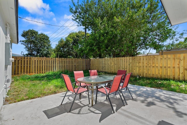2949 NE 12th Ter, Pompano Beach, FL 33064 - fenced backyard with outdoor dining space and a patio area