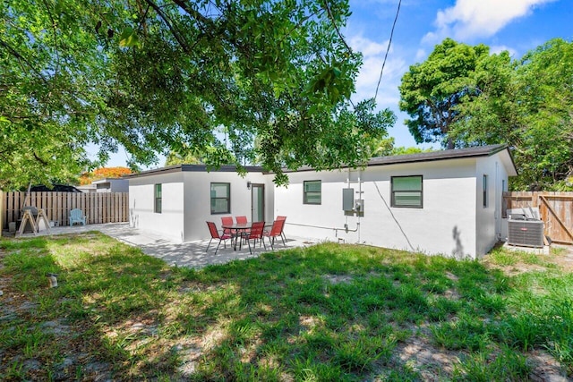 2949 NE 12th Ter, Pompano Beach, FL 33064 - rear view of property featuring stucco siding, central air condition unit, and a patio