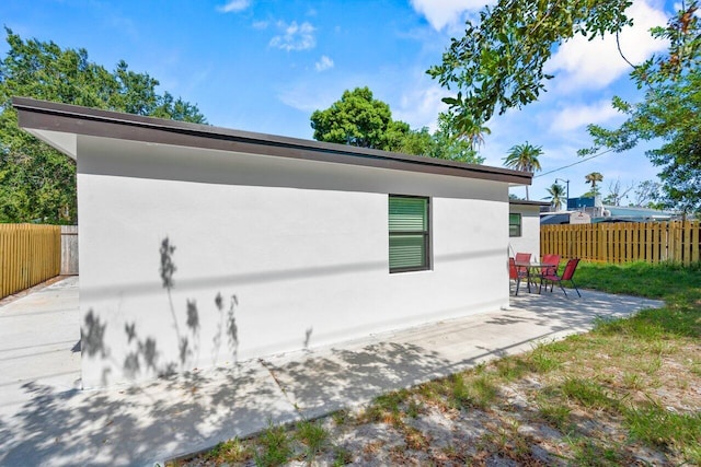 2949 NE 12th Ter, Pompano Beach, FL 33064 - view of home's exterior featuring a patio area and stucco siding