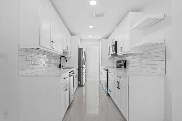 2949 NE 12th Ter, Pompano Beach, FL 33064 - kitchen featuring appliances with stainless steel finishes, a sink, recessed lighting, light countertops, and tasteful backsplash