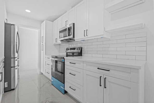 2949 NE 12th Ter, Pompano Beach, FL 33064 - kitchen with appliances with stainless steel finishes, light marble finish floors, white cabinets, decorative backsplash, and recessed lighting