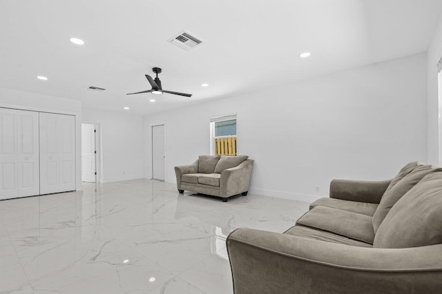 2949 NE 12th Ter, Pompano Beach, FL 33064 - living room featuring light marble finish flooring, a ceiling fan, recessed lighting, and baseboards