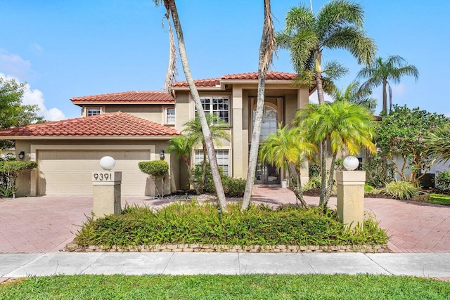 9391 Aqua Vista Blvd, Boynton Beach, FL 33437 - mediterranean / spanish-style home featuring stucco siding, decorative driveway, a garage, and a tile roof