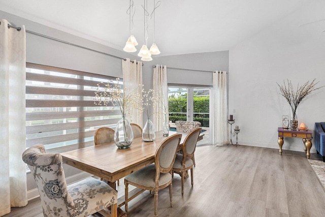9391 Aqua Vista Blvd, Boynton Beach, FL 33437 - dining space with a chandelier, lofted ceiling, light wood-type flooring, and baseboards