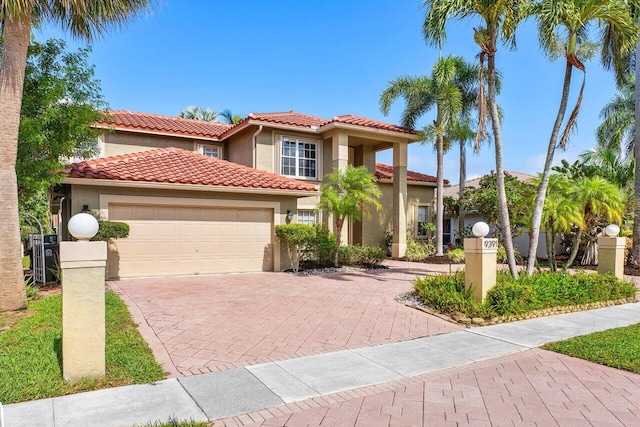 9391 Aqua Vista Blvd, Boynton Beach, FL 33437 - mediterranean / spanish home featuring stucco siding, decorative driveway, a garage, and a tile roof