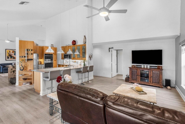 9391 Aqua Vista Blvd, Boynton Beach, FL 33437 - living area featuring high vaulted ceiling, a ceiling fan, and light wood-type flooring