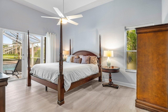 9391 Aqua Vista Blvd, Boynton Beach, FL 33437 - bedroom featuring access to exterior, light wood-type flooring, baseboards, high vaulted ceiling, and a ceiling fan
