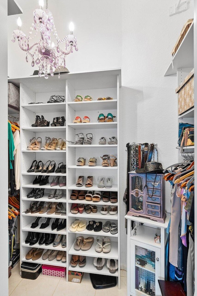 9391 Aqua Vista Blvd, Boynton Beach, FL 33437 - walk in closet with tile patterned floors and a chandelier