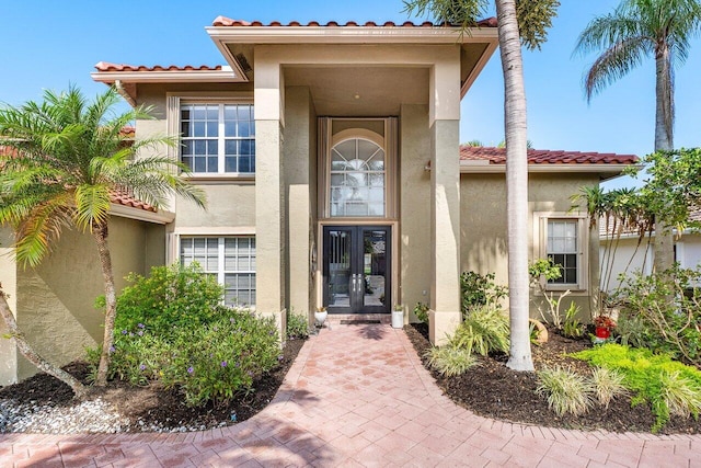 9391 Aqua Vista Blvd, Boynton Beach, FL 33437 - doorway to property with french doors, stucco siding, and a tiled roof