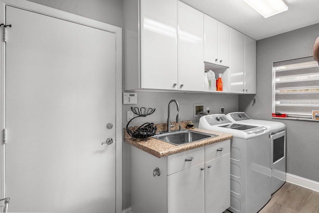 9391 Aqua Vista Blvd, Boynton Beach, FL 33437 - washroom featuring cabinet space, separate washer and dryer, light wood finished floors, and baseboards