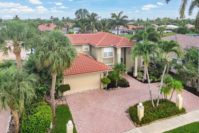 9391 Aqua Vista Blvd, Boynton Beach, FL 33437 - mediterranean / spanish-style home with stucco siding, a tiled roof, decorative driveway, and an attached garage