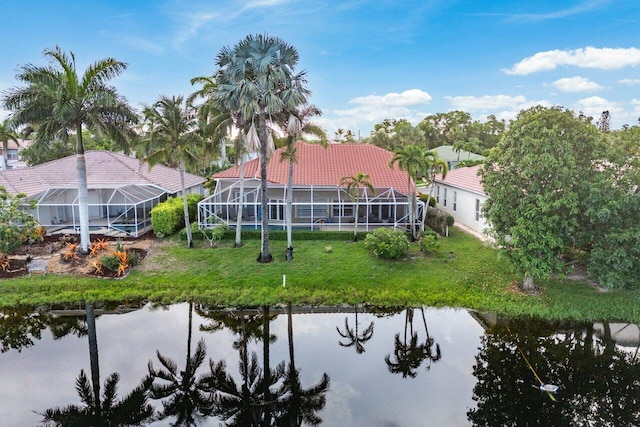 9391 Aqua Vista Blvd, Boynton Beach, FL 33437 - back of property with a water view, a tile roof, glass enclosure, and a lawn