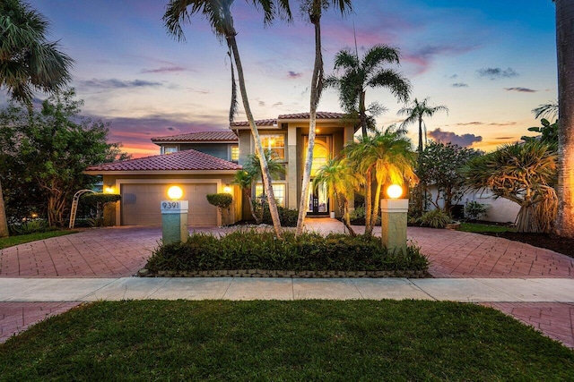 9391 Aqua Vista Blvd, Boynton Beach, FL 33437 - mediterranean / spanish-style house with a tiled roof, decorative driveway, a garage, and stucco siding