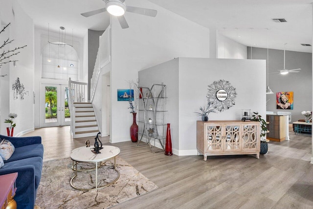 9391 Aqua Vista Blvd, Boynton Beach, FL 33437 - living area featuring high vaulted ceiling, ceiling fan, wood finished floors, stairs, and baseboards