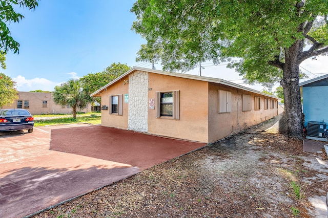 928 S H St Unit 1, Lake Worth, FL 33460 - view of home's exterior with stucco siding and cooling unit