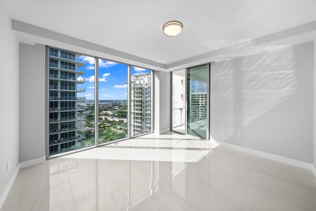 3100 N Ocean Dr Unit H-1608, Singer Island, FL 33404 - tiled empty room with a city view and baseboards