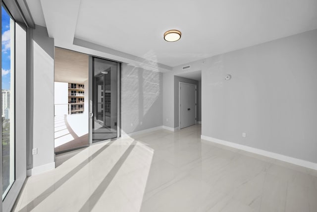 3100 N Ocean Dr Unit H-1608, Singer Island, FL 33404 - spare room featuring healthy amount of natural light and baseboards
