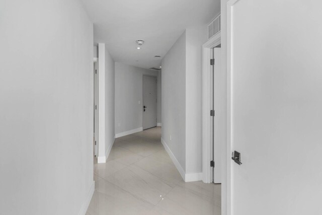 3100 N Ocean Dr Unit H-1608, Singer Island, FL 33404 - hallway with baseboards and light tile patterned floors