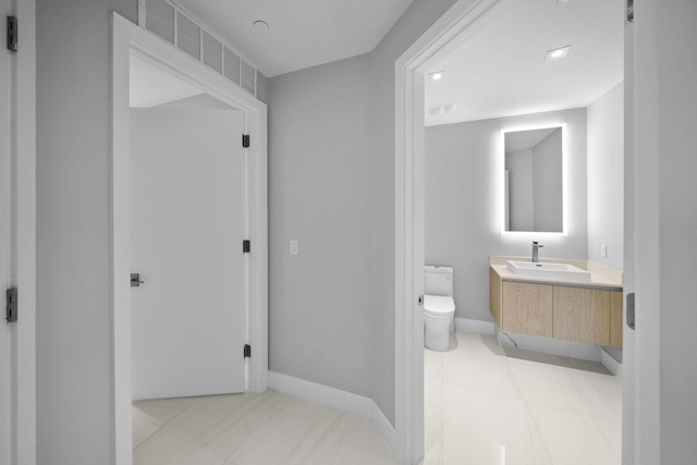3100 N Ocean Dr Unit H-1608, Singer Island, FL 33404 - bathroom with toilet, vanity, tile patterned flooring, and baseboards