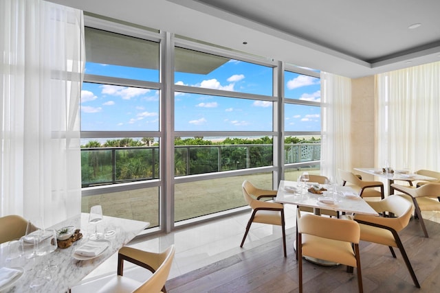 3100 N Ocean Dr Unit H-1608, Singer Island, FL 33404 - dining room with plenty of natural light, wood finished floors, and a water view