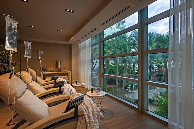 3100 N Ocean Dr Unit H-1608, Singer Island, FL 33404 - living room with wood finished floors, recessed lighting, and a tray ceiling