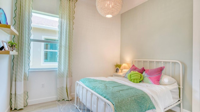 1297 SE Crosswood Way, Port Saint Lucie, FL 34984 - bedroom featuring baseboards and wood finished floors