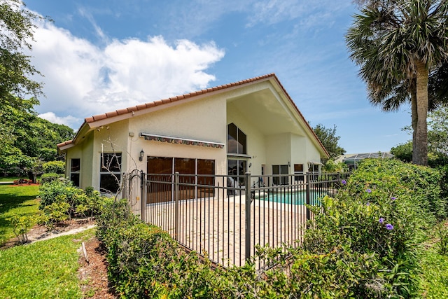 1414 SW Osprey Cv, Port Saint Lucie, FL 34986 - view of side of property with stucco siding, a tile roof, and a patio area