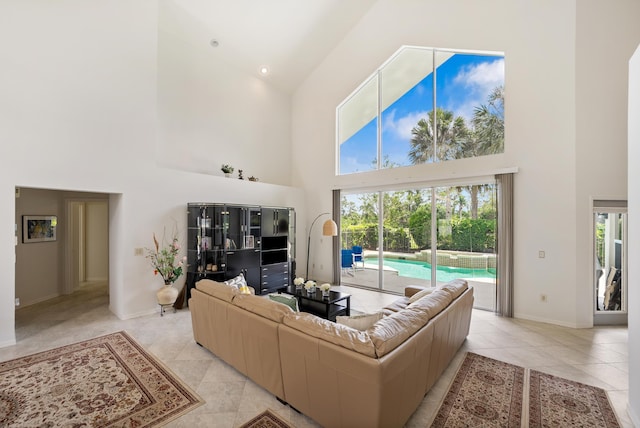 1414 SW Osprey Cv, Port Saint Lucie, FL 34986 - living area featuring high vaulted ceiling, light tile patterned flooring, and baseboards