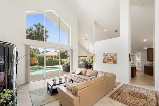 1414 SW Osprey Cv, Port Saint Lucie, FL 34986 - living area with high vaulted ceiling, light tile patterned floors, recessed lighting, and baseboards