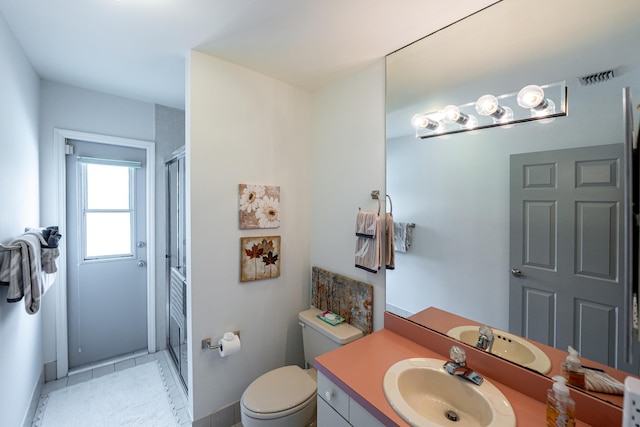 1414 SW Osprey Cv, Port Saint Lucie, FL 34986 - bathroom with vanity, a shower stall, toilet, baseboards, and tile patterned flooring