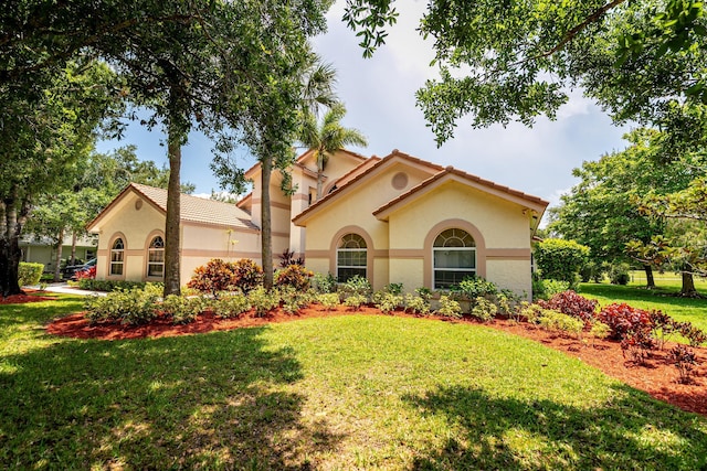 1414 SW Osprey Cv, Port Saint Lucie, FL 34986 - mediterranean / spanish-style home with stucco siding and a front lawn