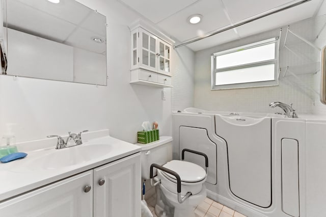 160 Tuscany C, Delray Beach, FL 33446 - full bath with toilet, a bath, tile patterned floors, vanity, and recessed lighting