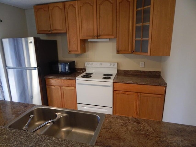 3721 37th Way, West Palm Beach, FL 33407 - kitchen with electric range, freestanding refrigerator, black microwave, dark countertops, and glass insert cabinets