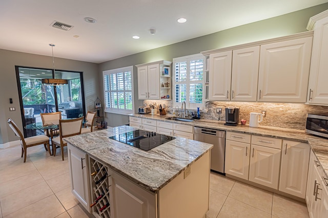 8060 Kiawah Trce, Port Saint Lucie, FL 34986 - kitchen featuring stainless steel appliances, a sink, light tile patterned flooring, a kitchen island, and backsplash